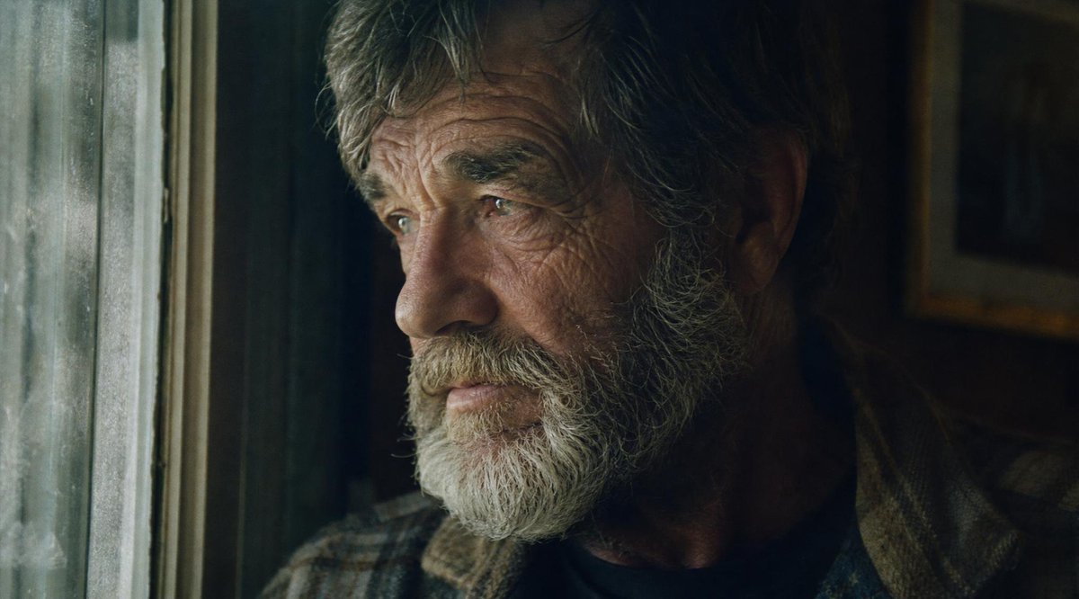 Create a cinematic, moody film-still portrait in a 16:9 widescreen frame of {argument name="character description" defa…